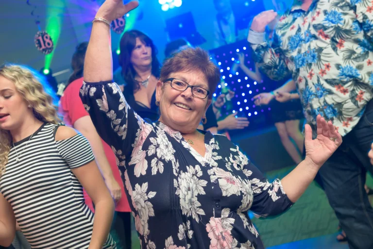 Birthday mum dancing. Green Mobile disco light beams in the background.